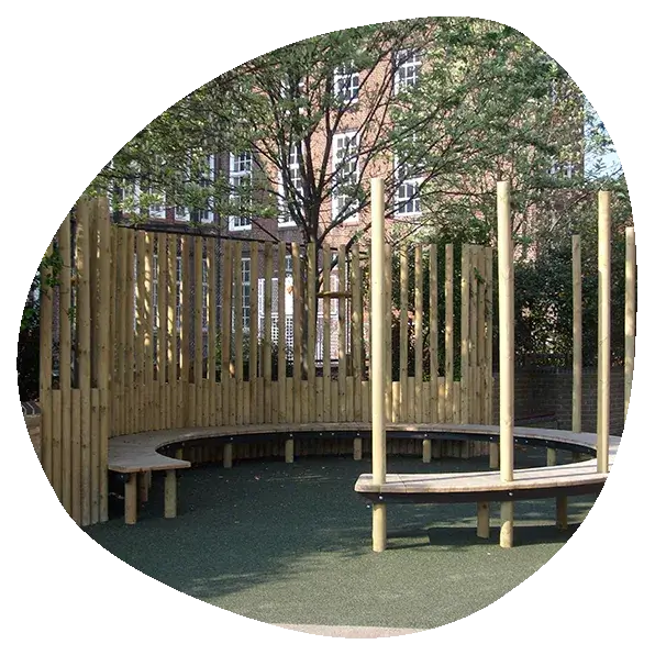 A circular wooden structure with a bench in the middle of it.